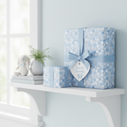 Gifts wrapped in light blue polka dot baby shower wrapping paper with matching ribbon and "Sweet Dreams" tag.