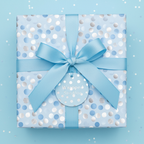 Baby blue gift box wrapped in polka dot paper with a satin ribbon bow.