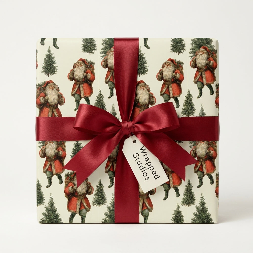 Vintage Santa Christmas wrapping paper tied with a red satin ribbon by Wrapped Studios.