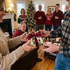 Family exchanging a gift with vintage Santa Christmas wrapping paper and red ribbon by Wrapped Studios.
