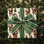 Vintage Santa Christmas wrapping paper with a green fabric ribbon and Wrapped Studios gift tag.