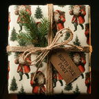 Vintage Santa Claus Christmas gift wrap tied with rustic twine and a pine sprig by Wrapped Studios.