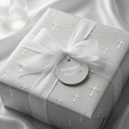 Silver cross baptism and christening wrapping paper with a white ribbon by Wrapped Studios.