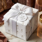 First Holy Communion wrapping paper with a luxury white satin bow on a gift box, by Wrapped Studios.