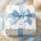 First Communion wrapping paper with blue satin bow and dove tag on a baptism gift, by Wrapped Studios.