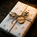 First communion wrapping paper with vintage baptism sketch pattern and blessings tag by Wrapped Studios.