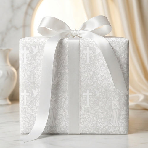 Elegant baptism wrapping paper with crosses and angels, tied with a white satin bow by Wrapped Studios.