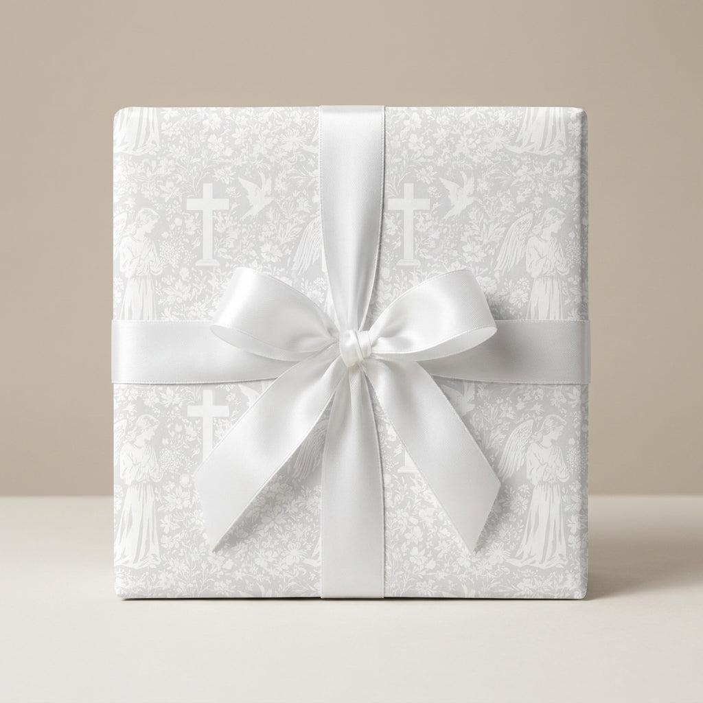 White baptism wrapping paper with vintage angels and crosses and a satin bow by Wrapped Studios.