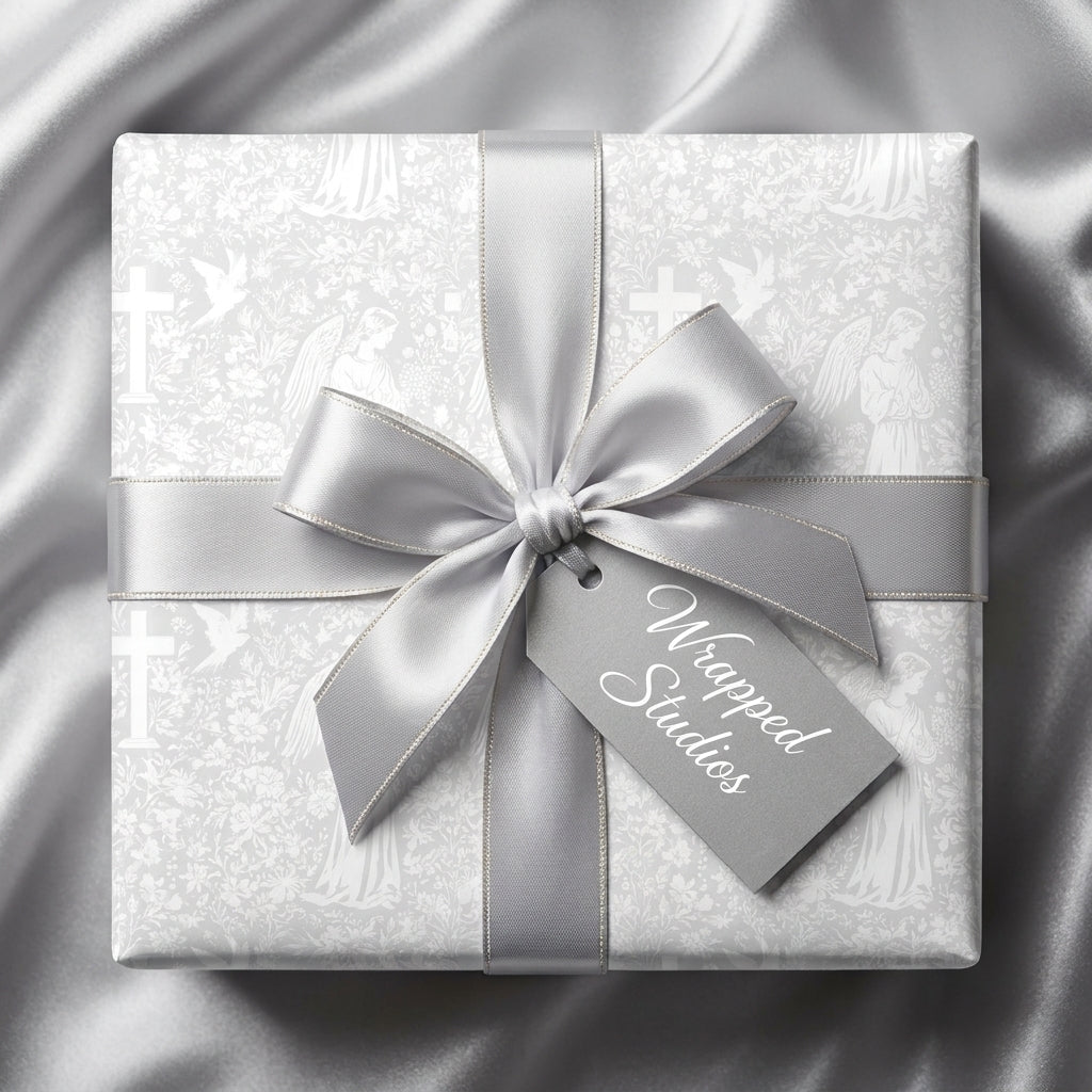 Elegant baptism wrapping paper with silver crosses and angels, tied with a satin ribbon by Wrapped Studios.
