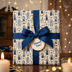 Bar Mitzvah wrapping paper with a navy blue bow and Mazel Tov tag by Wrapped Studios.