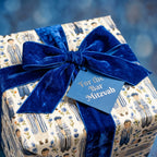 Bar Mitzvah wrapping paper with watercolor boys, luxury blue velvet bow, and tag by Wrapped Studios.