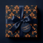 Luxury navy and gold damask wrapping paper with a satin bow and Wrapped Studios tag.