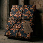 Luxury navy and bronze damask wrapping paper with rustic twine and a Wrapped Studios gift tag.