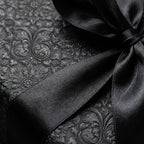 Luxury black damask wrapping paper with an elegant black satin bow by Wrapped Studios.