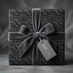 Luxury black damask wrapping paper with a grey velvet bow and gift tag by Wrapped Studios.