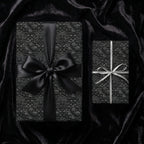 Luxury black gothic floral wrapping paper with elegant bows by Wrapped Studios.
