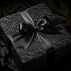 Luxury black gothic floral wrapping paper with a satin ribbon on a gift box by Wrapped Studios.