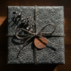 Luxury dark gothic wrapping paper with a twine bow and handmade tag by Wrapped Studios.
