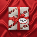 Gift wrapped in baseball pattern paper with red ribbon, perfect for a baseball fan's birthday present.
