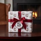 Baseball wrapping paper on a gift with burgundy ribbon. "Play Ball!" gift tag attached.
