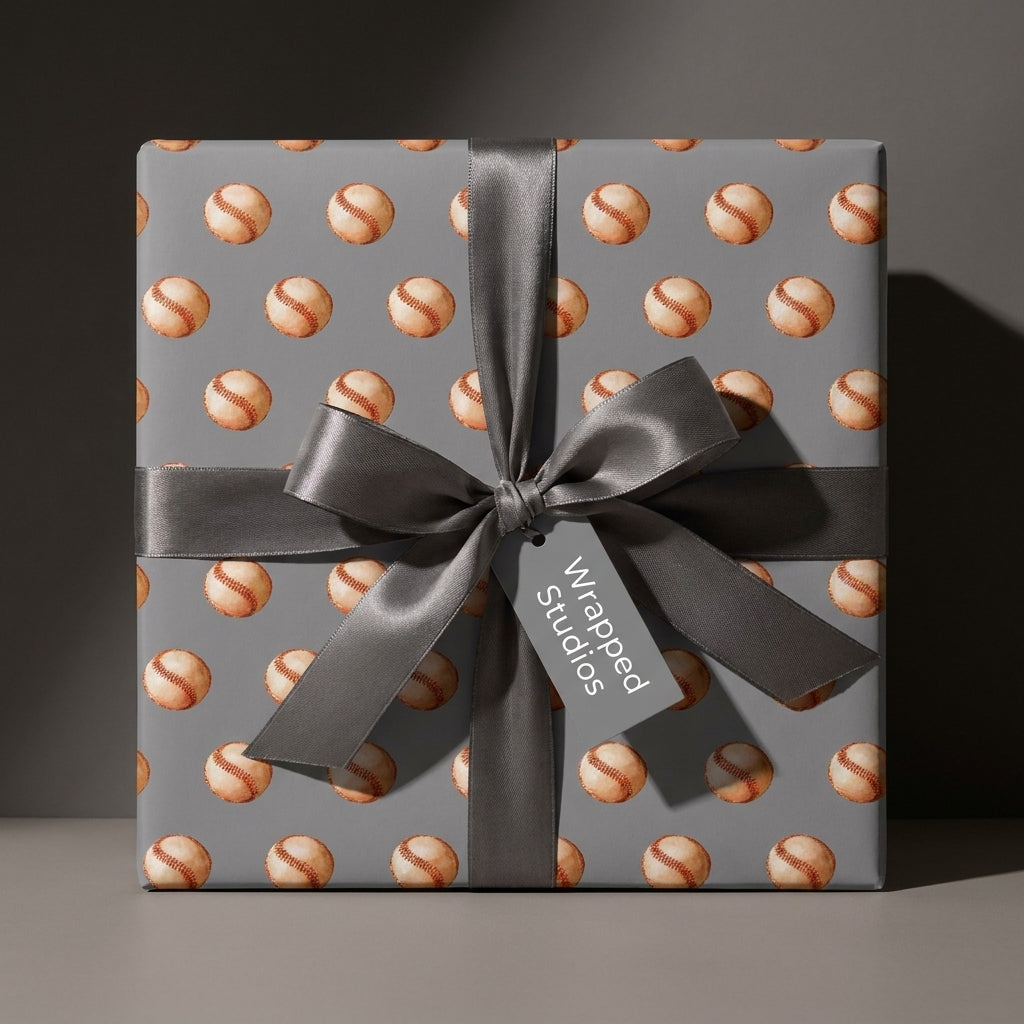 Vintage baseball wrapping paper on a grey gift box with a satin bow by Wrapped Studios.