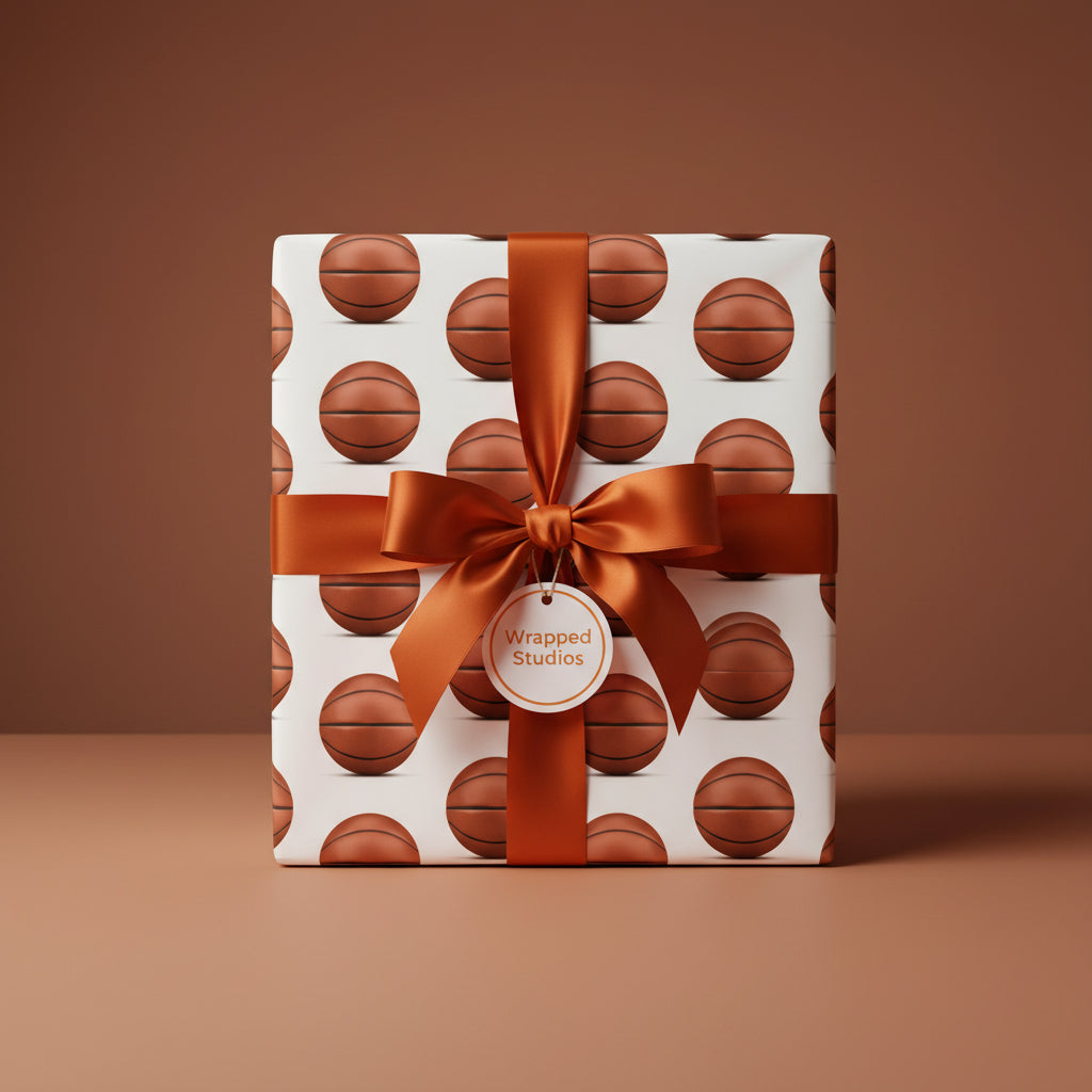 Wrapped Studios basketball wrapping paper with satin ribbon bow, perfect for sports fans.
