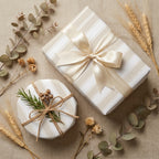 Elegant neutral striped wrapping paper with a cream satin bow and rustic twine by Wrapped Studios.