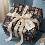 Luxury jellyfish wrapping paper with a cream velvet bow and gift tag by Wrapped Studios.