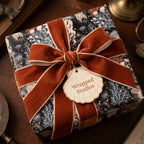 Luxury ocean botanical wrapping paper with a rust velvet ribbon and seashell tag by Wrapped Studios.