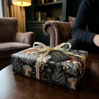 Luxury dark academia wrapping paper with vintage jellyfish illustration on a gift box by Wrapped Studios.