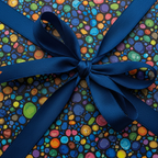 Top-down view of a gift wrapped in colorful dot pattern wrapping paper with a navy blue ribbon.