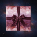 Square gift wrapped in luxury cosmic galaxy wrapping paper with velvet burgundy ribbon and bow.