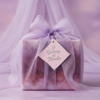 Elegant thank you gift wrapped in purple galaxy-themed wrapping paper with sheer ribbon and tag.