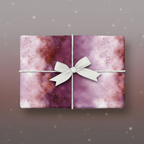 Elegant gift wrapped in purple galaxy wrapping paper with a white ribbon.