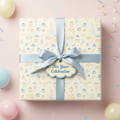 Celebration gift wrapped in cake pattern wrapping paper with a blue satin ribbon and bow.