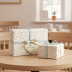 Cake-themed birthday wrapping paper with blue ribbon and "Perfect Pair" tag.