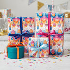 Colorful birthday wrapping paper with cupcakes, balloons, and candle pattern, tied with pink, blue, and orange ribbons.