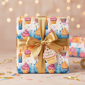 Wrapped birthday gift with cupcake print paper, tied with gold ribbon and "Happy Birthday" tag.