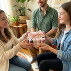 Woman hands a square birthday gift with a cupcake wrapping paper pattern and pink bow to a smiling girl.