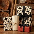 Vintage baseball wrapping paper by Wrapped Studios on rustic gift boxes with black ribbon.