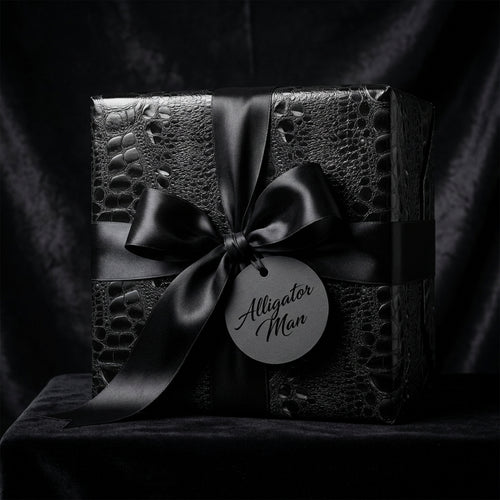 Black luxury gift wrap with an alligator skin pattern and satin ribbon, perfect for elegant birthday presents.