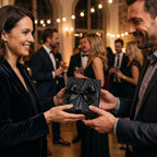 Woman exchanges gift wrapped in black floral wrapping paper with a black ribbon.