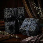 Elegant gifts wrapped in black floral wrapping paper and silk ribbon bows from Wrapped Studios.