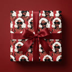 Glamorous Christmas wrapping paper featuring Black women in Santa hats and a red bow by Wrapped Studios.