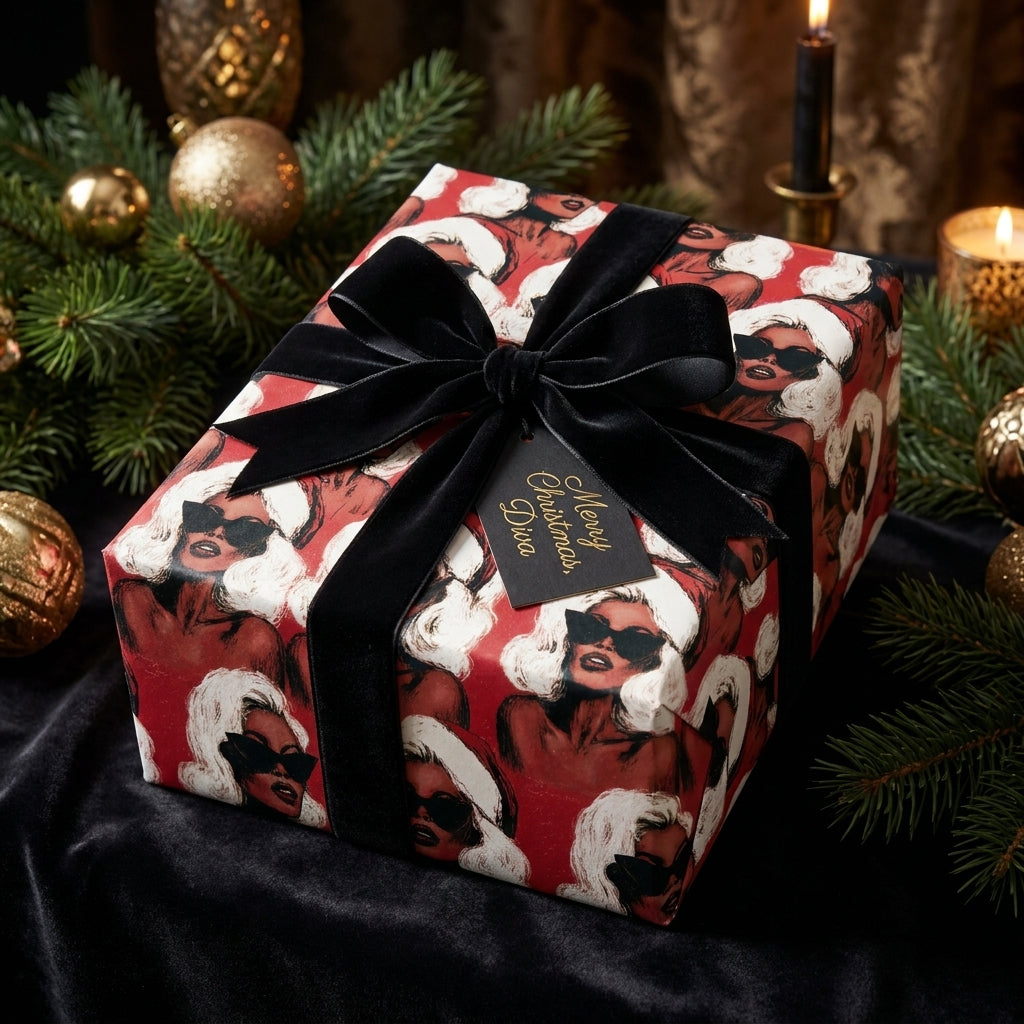 Luxury diva Christmas wrapping paper on a gift box with a black velvet bow by Wrapped Studios.