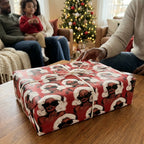 Red Christmas wrapping paper with chic Black women in Santa hats on a gift box by Wrapped Studios.