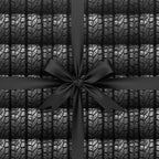 Novelty gift wrap with a tire tread pattern and a black satin bow.