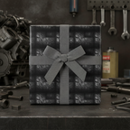 Gift wrapped in tire tread wrapping paper with gray ribbon bow, in an auto shop.
