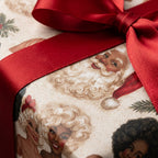 Vintage Black Santa Christmas wrapping paper with a red satin bow by Wrapped Studios.