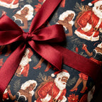 Black Santa and Mrs. Claus vintage Christmas gift wrap with a red satin bow by Wrapped Studios.
